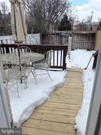 a view of balcony with wooden floor and outdoor seating