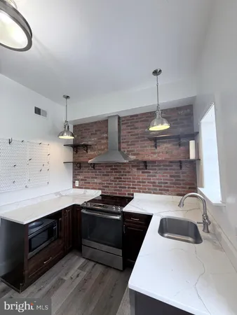 a kitchen with a stove and a sink