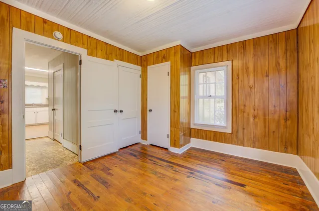 a view of a room with wooden floor and a bathroom