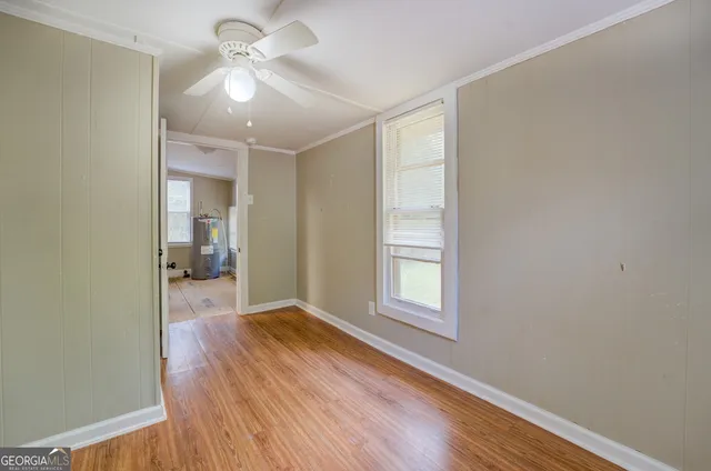 wooden floor in an empty room with a window