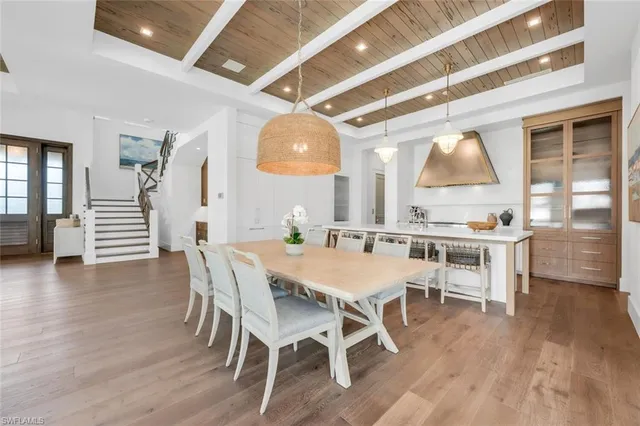 a large white bed sitting in a bedroom next to a window