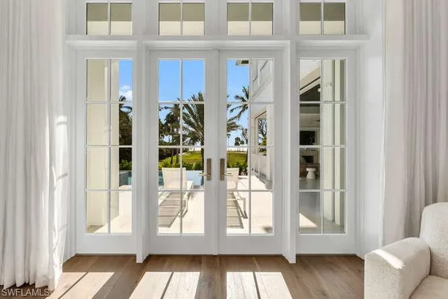 a kitchen with stainless steel appliances kitchen island granite countertop a stove and white cabinets