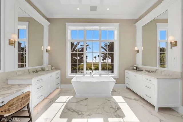 a dining room with furniture and a floor to ceiling window