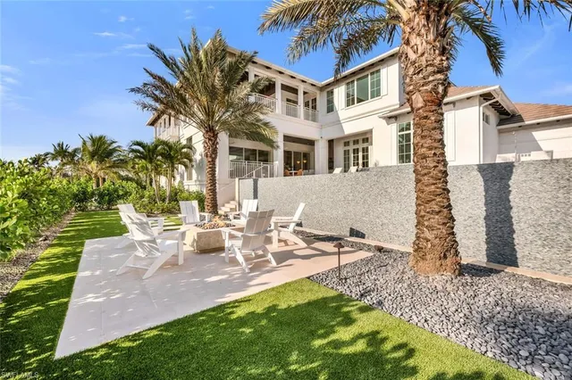 a view of a swimming pool in front of residential houses with outdoor space