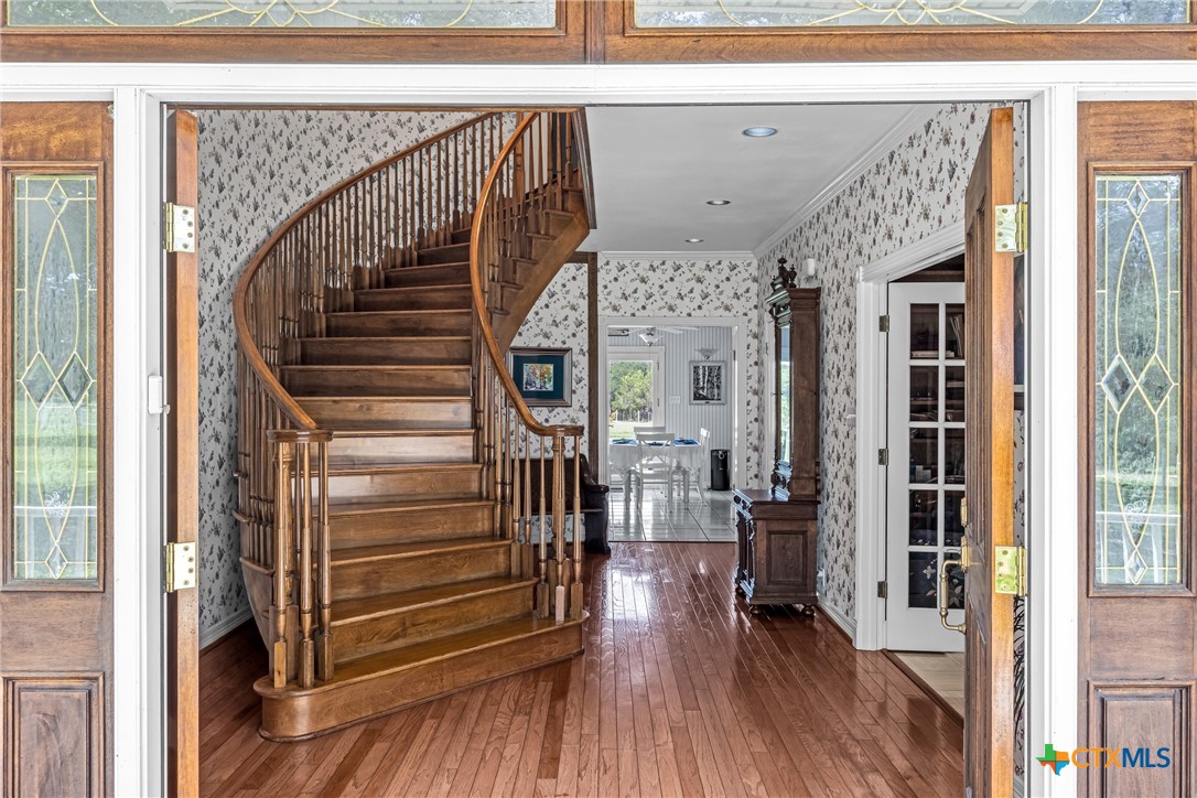 10299 Paddy Hamilton Road Belton, TX 76513 - Photo 12 of 46 a view of a hallway with wooden floor and staircase