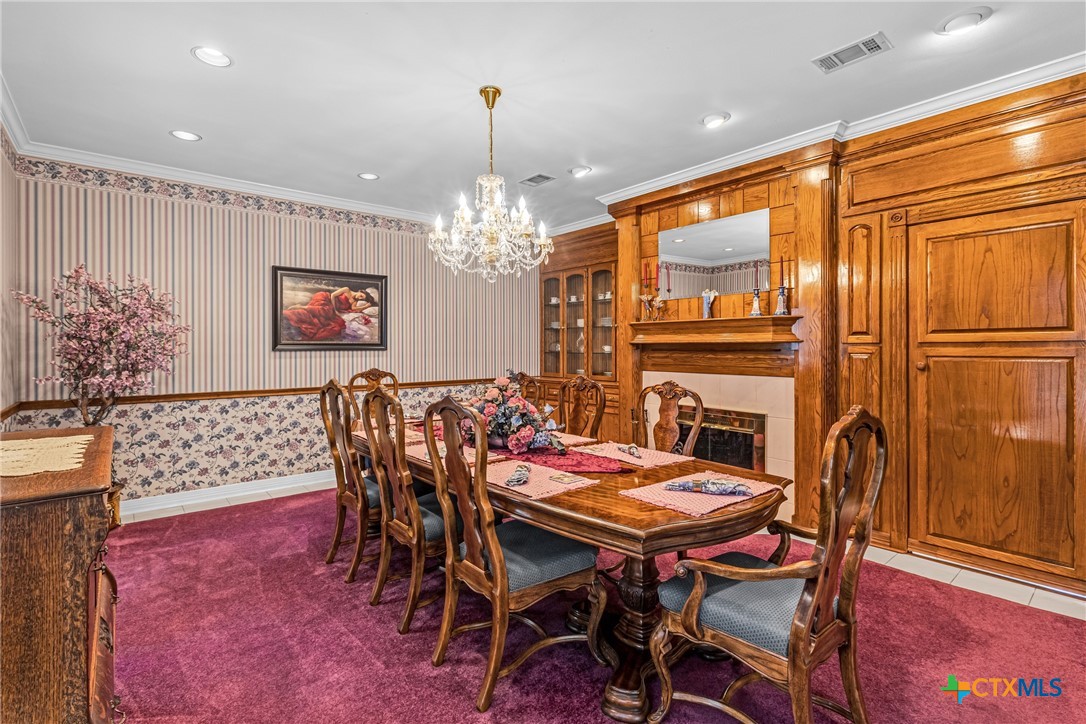 10299 Paddy Hamilton Road Belton, TX 76513 - Photo 16 of 46 a dining room with furniture a chandelier and wooden floor