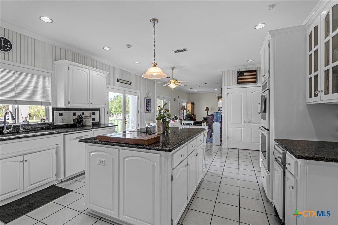10299 Paddy Hamilton Road Belton, TX 76513 - Photo 18 of 46 a kitchen with white cabinets and sink