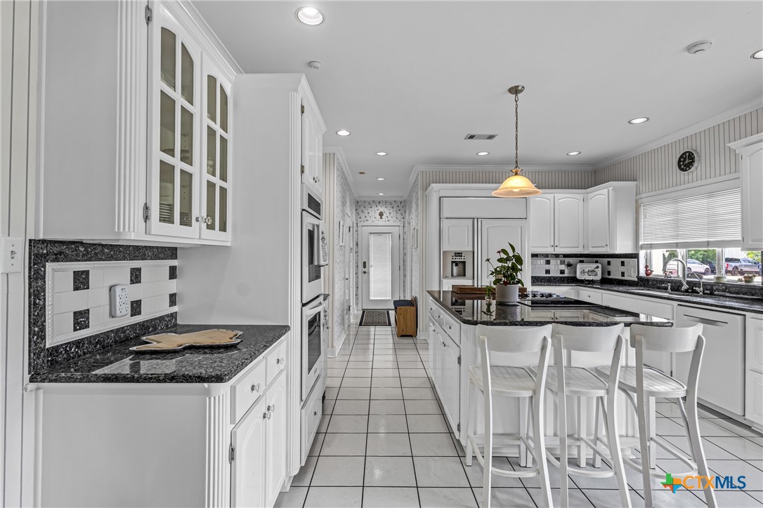 10299 Paddy Hamilton Road Belton, TX 76513 - Photo 21 of 46 a kitchen with stainless steel appliances granite countertop a stove and a cabinets