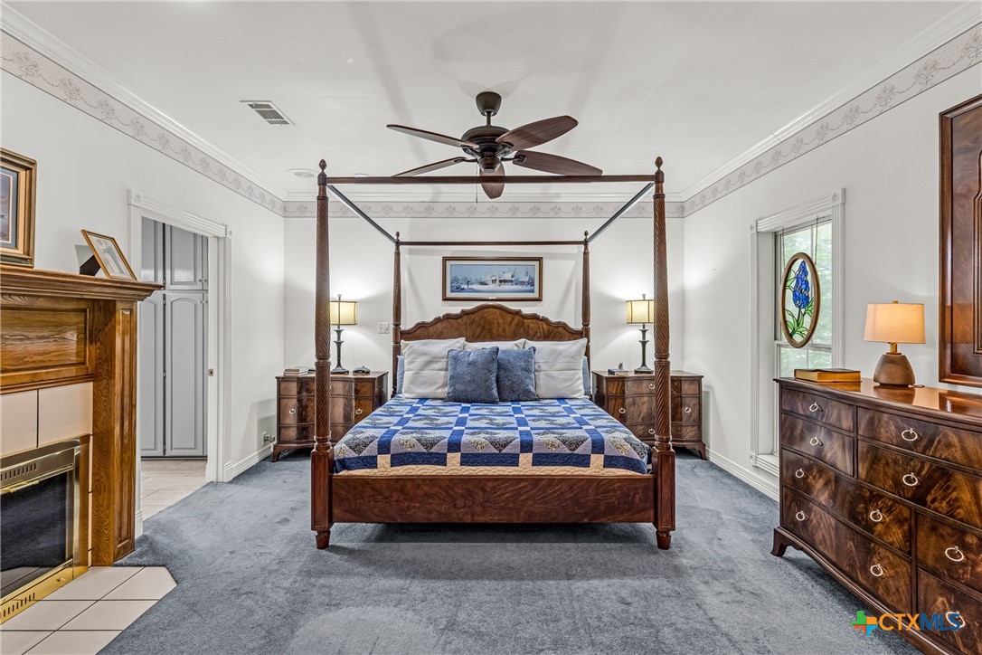 10299 Paddy Hamilton Road Belton, TX 76513 - Photo 32 of 46 a bedroom with a bed and a chandelier