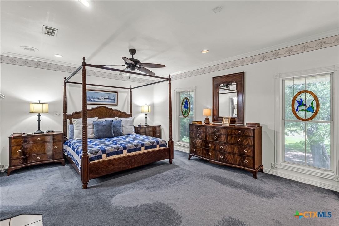 10299 Paddy Hamilton Road Belton, TX 76513 - Photo 33 of 46 a bedroom with a bed and a lamp on table