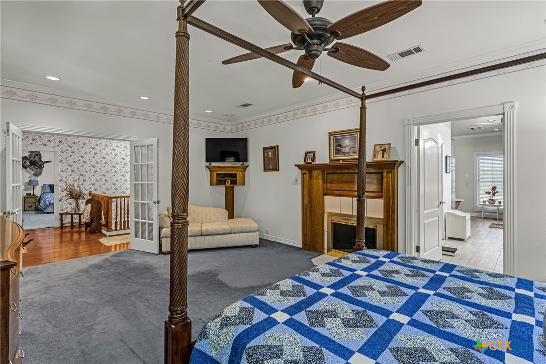 10299 Paddy Hamilton Road Belton, TX 76513 - Photo 34 of 46 a bedroom with a bed a table and flat screen tv