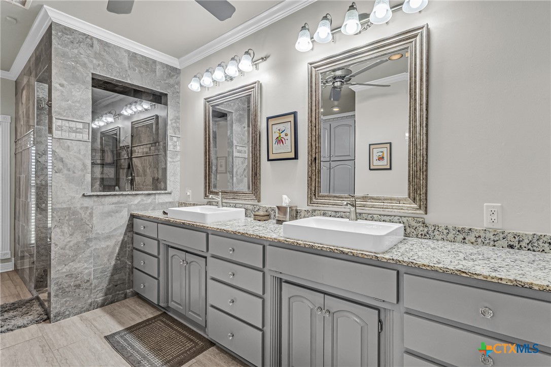 10299 Paddy Hamilton Road Belton, TX 76513 - Photo 36 of 46 a bathroom with double vanity sinks and a mirror