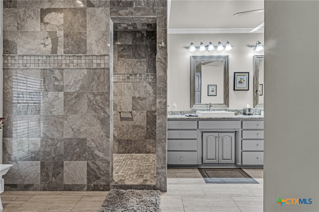10299 Paddy Hamilton Road Belton, TX 76513 - Photo 37 of 46 a bathroom with a double vanity sink and a mirror
