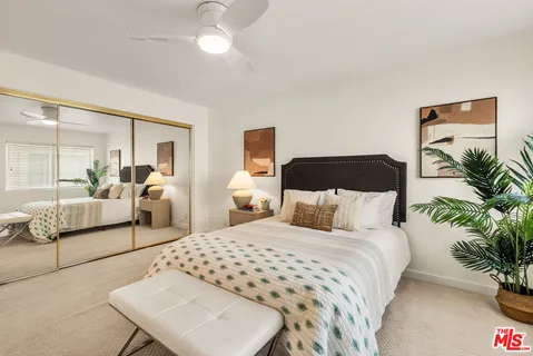 a bedroom with a large bed and a couch