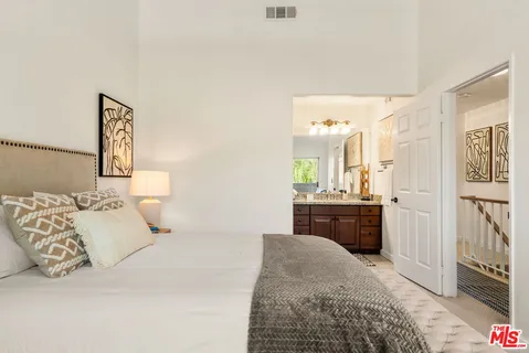 a bedroom with a bed and dresser