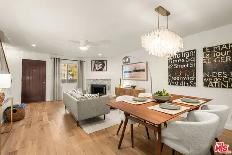 a living room with furniture a chandelier and a fireplace