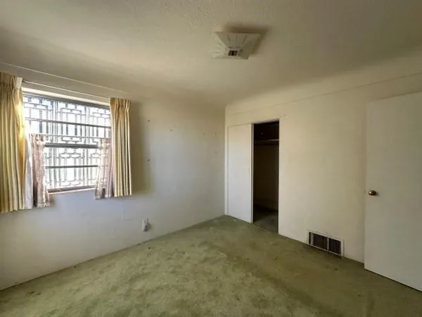 an empty room with a empty space and windows