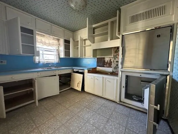a kitchen with stainless steel appliances a sink and a refrigerator