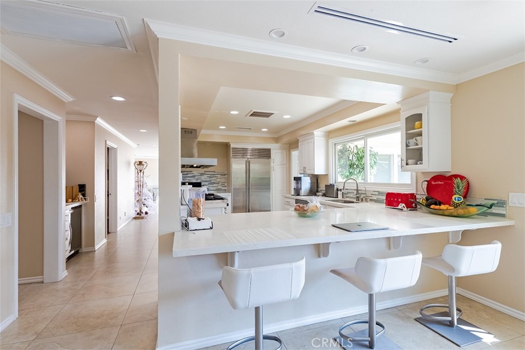 931 Rancho Circle Fullerton, CA 92835 - Photo 31 of 53 a dining hall with stainless steel appliances kitchen island granite countertop a dining table chairs and couches
