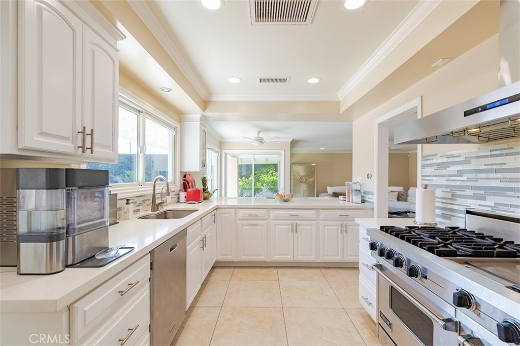 931 Rancho Circle Fullerton, CA 92835 - Photo 34 of 53 a large white kitchen with stainless steel appliances granite countertop a stove and a sink