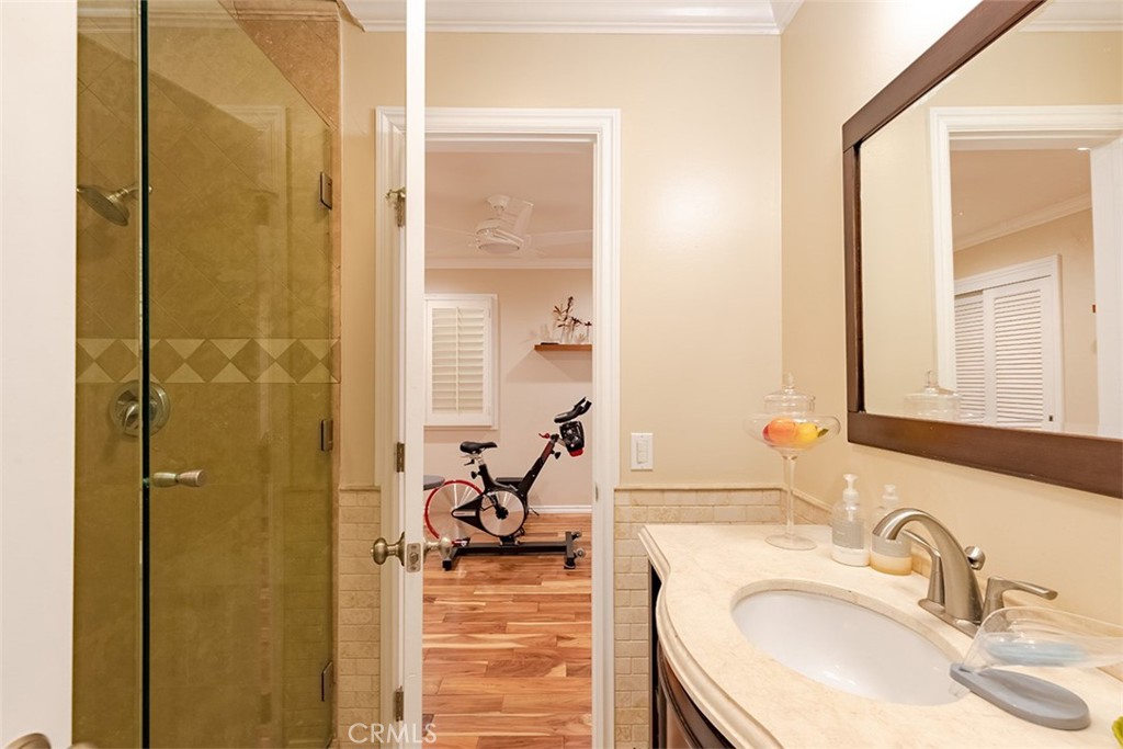 931 Rancho Circle Fullerton, CA 92835 - Photo 52 of 53 a bathroom with a granite countertop sink a mirror and shower