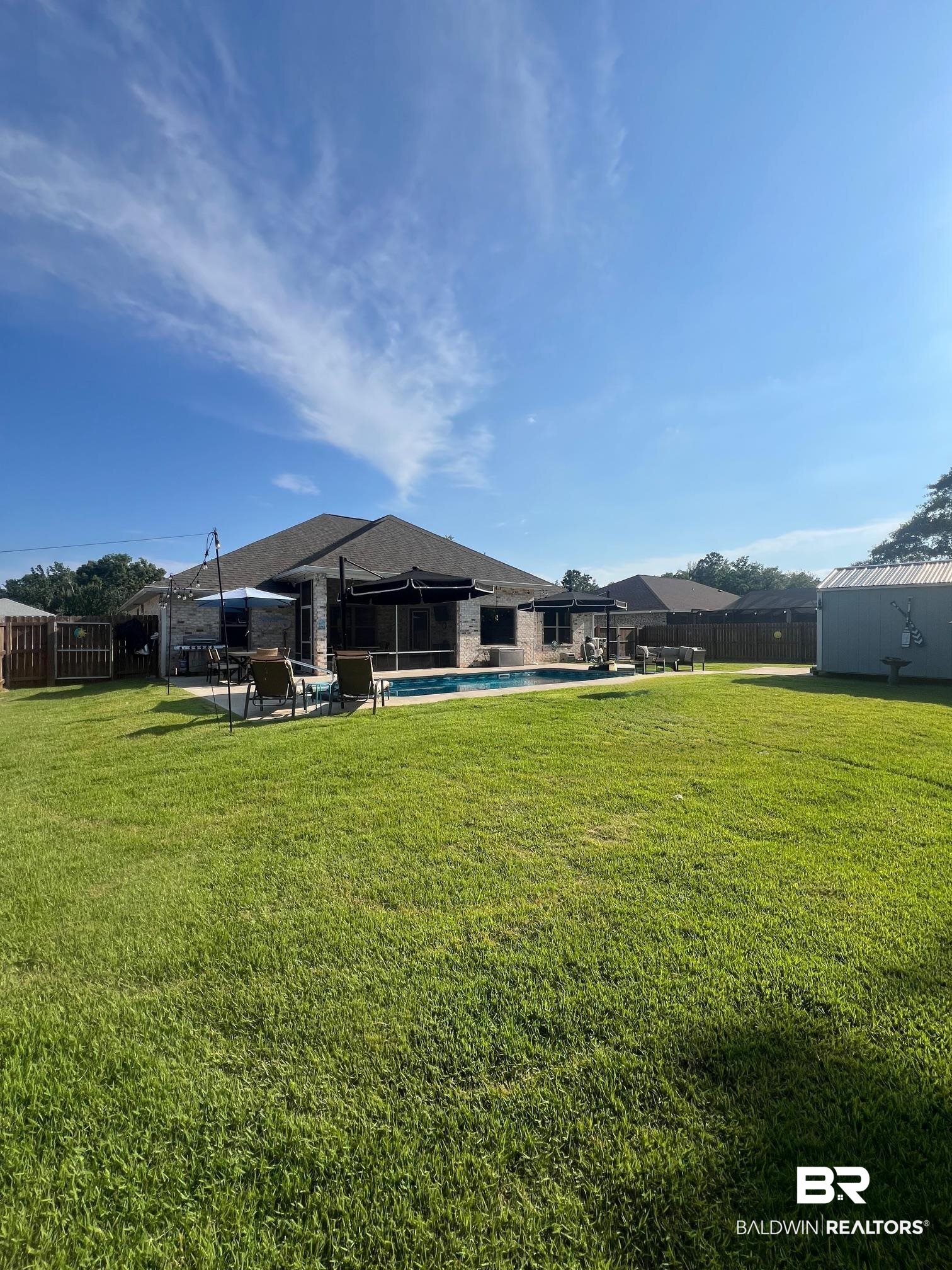 32915 Arbor Ridge Circle Lillian, AL 36549 - Photo 20 of 26 Fenced backyard with a swimming pool and a patio
