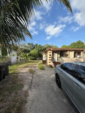 a view of a car parked in front of a house
