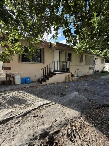 a view of a house with a tree