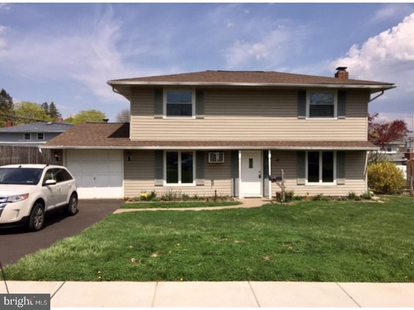 18 Tempo Road Levittown, PA 19056 - Photo 2 of 22 a front view of a house with a garden and yard