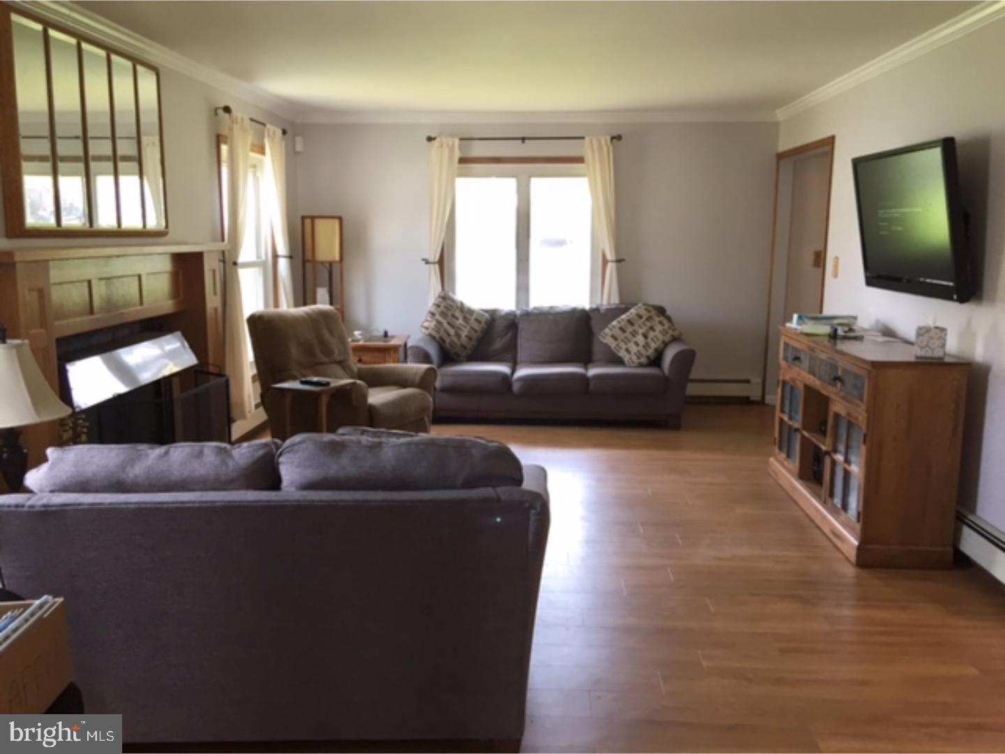 18 Tempo Road Levittown, PA 19056 - Photo 11 of 22 a living room with furniture and a flat screen tv