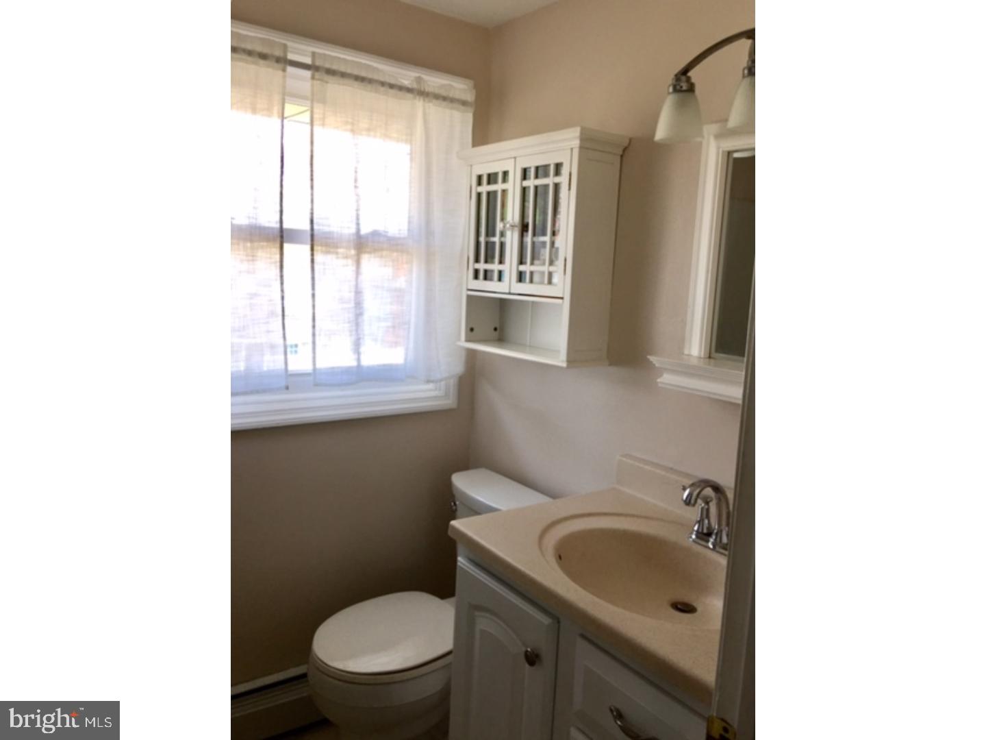 18 Tempo Road Levittown, PA 19056 - Photo 15 of 22 a bathroom with a sink toilet and window