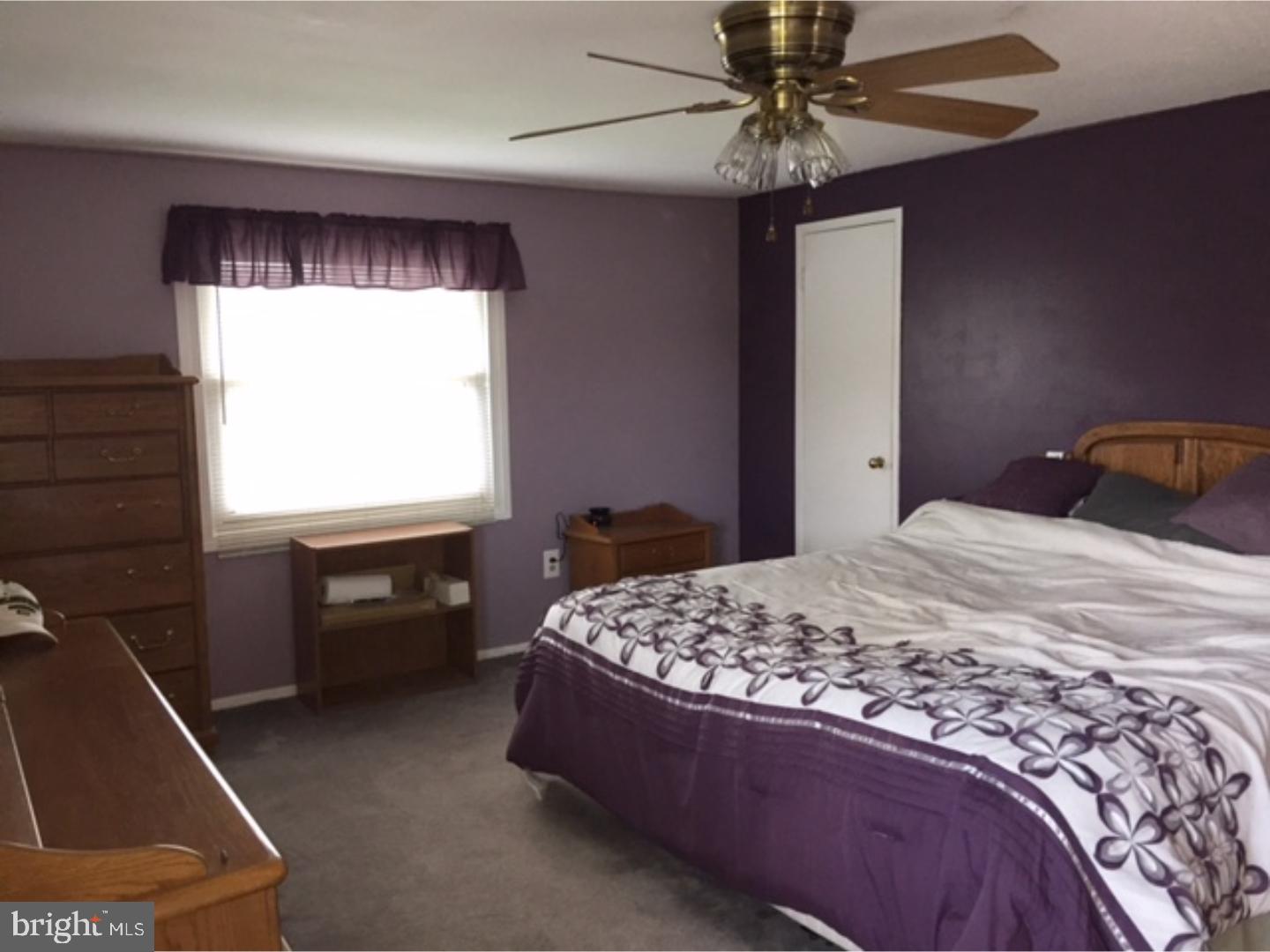 18 Tempo Road Levittown, PA 19056 - Photo 16 of 22 a bedroom with a bed and a chandelier