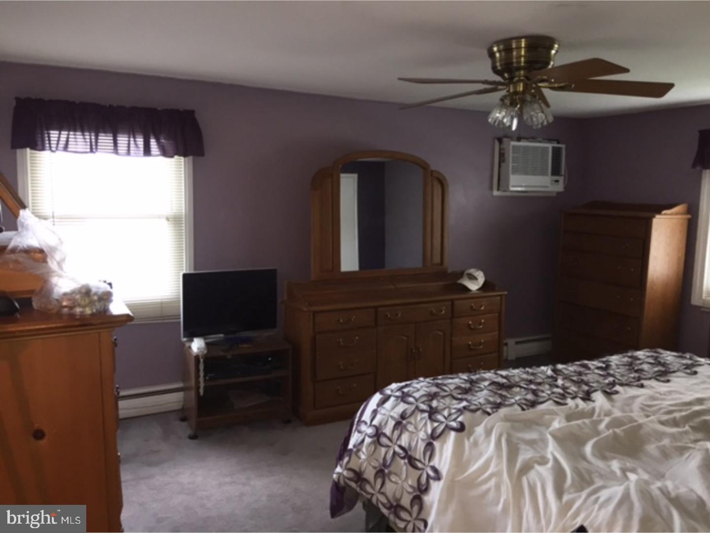 18 Tempo Road Levittown, PA 19056 - Photo 17 of 22 a bedroom with a bed and a flat tv screen on dresser