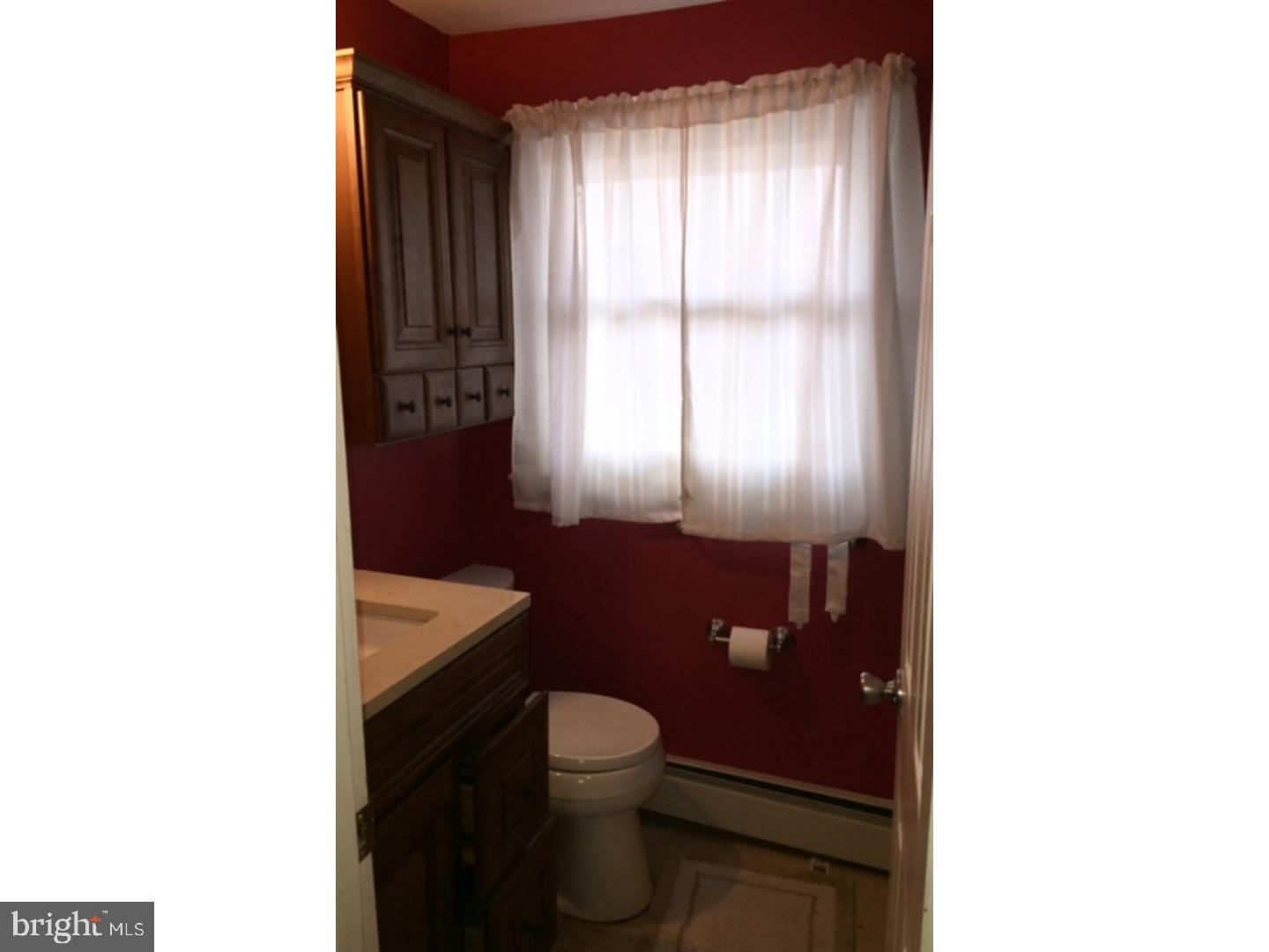 18 Tempo Road Levittown, PA 19056 - Photo 20 of 22 a bathroom with a toilet a sink and mirror