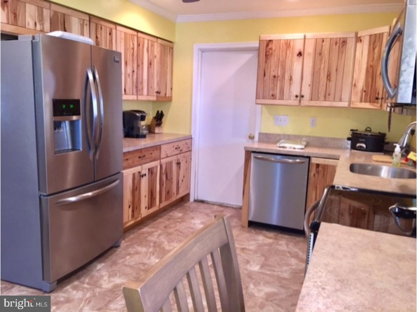 18 Tempo Road Levittown, PA 19056 - Photo 5 of 22 a kitchen with stainless steel appliances granite countertop a refrigerator a stove a sink dishwasher and microwave