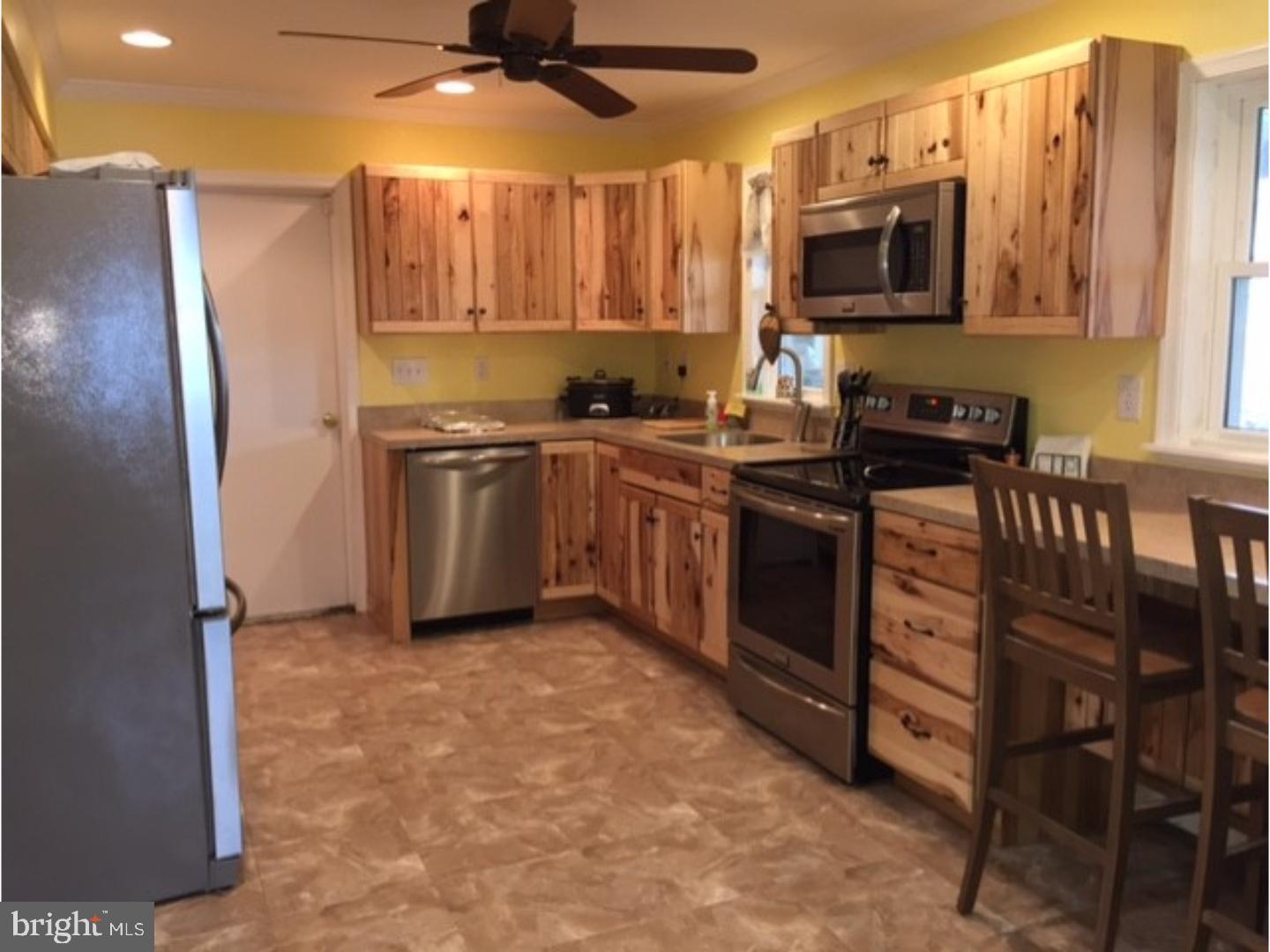 18 Tempo Road Levittown, PA 19056 - Photo 8 of 22 a kitchen with stainless steel appliances granite countertop a stove top oven a sink and a refrigerator