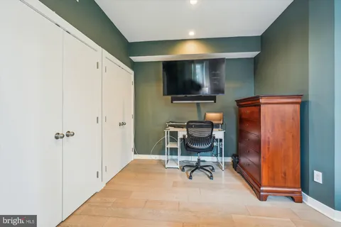 a living room with furniture a flat screen tv and a window