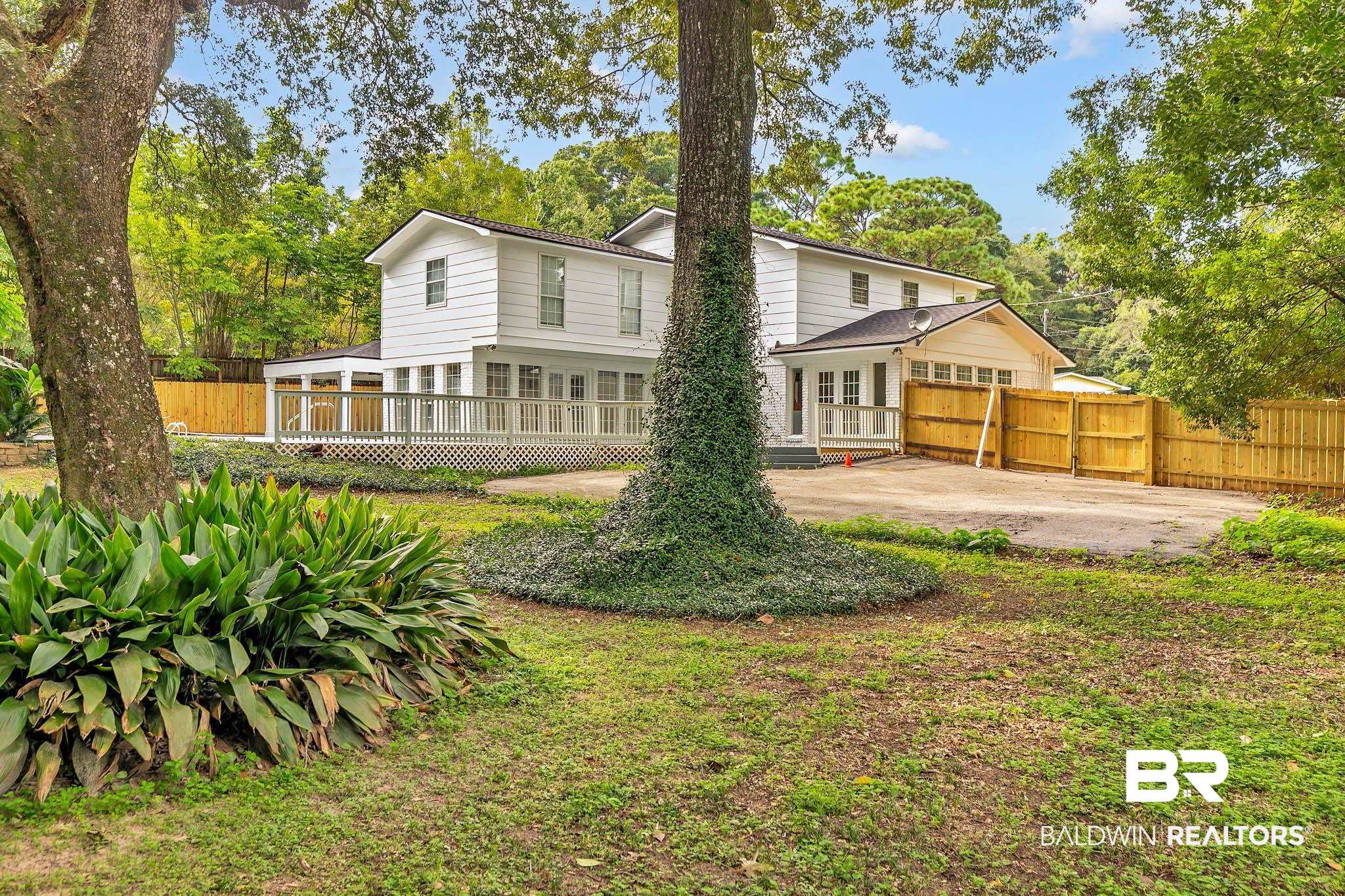 4705 Sherry Court Mobile, AL 36693 - Photo 57 of 100 Rear view of house with view of wooded area and a patio area