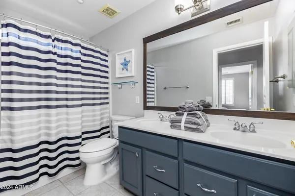 a bathroom with a sink a toilet and mirror