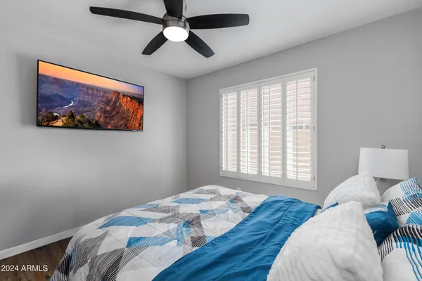 a bedroom with a large bed and a window
