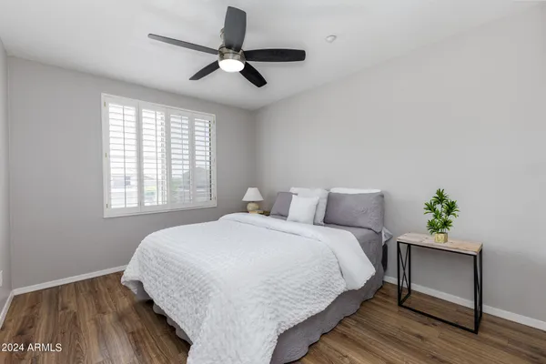 a bedroom with a bed and a potted plant