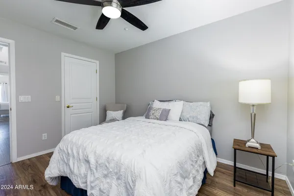 a bedroom with a bed and a lamp on the table