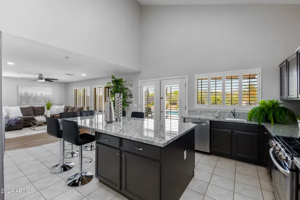 a kitchen with granite countertop a sink and a stove