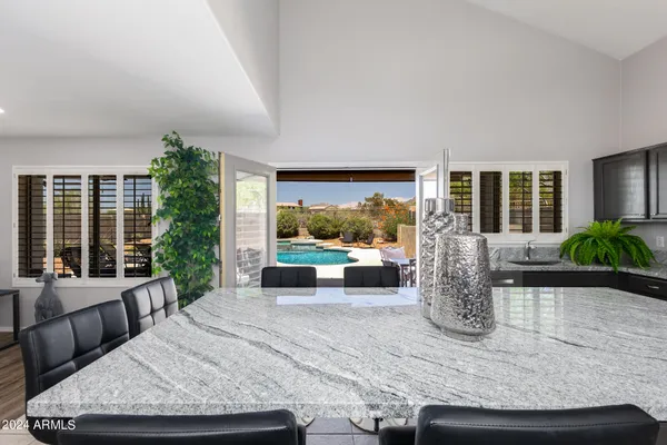 a living room with furniture large window and garden view