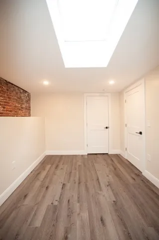a view of an empty room and wooden floor