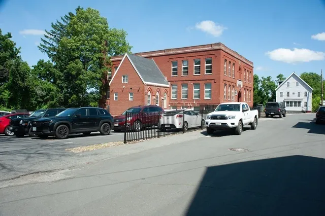 a view of a cars park in front of a building