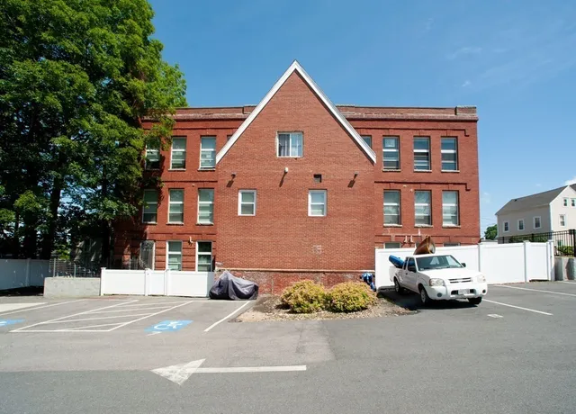 a front view of a house with parking