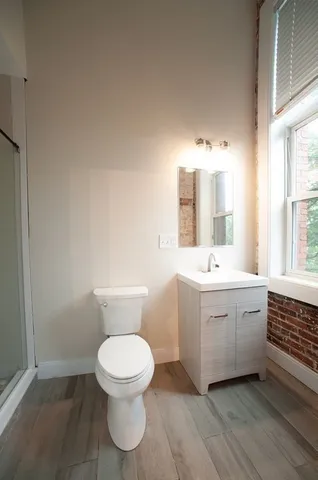 a bathroom with a sink mirror and toilet