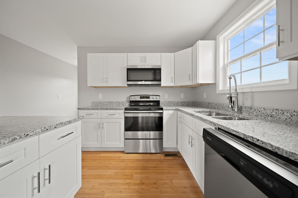 2236 Sullivan Knowles Road Sparta, TN 38583 - Photo 2 of 16 a kitchen with granite countertop a sink cabinets and stainless steel appliances