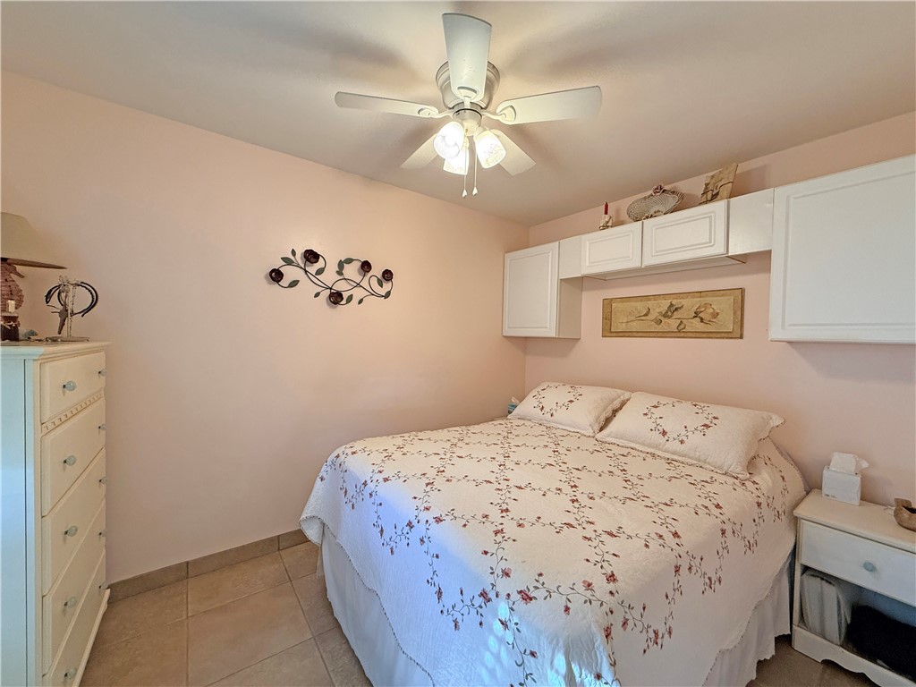 1411 Myrtle Street Fulton, TX 78358 - Photo 16 of 26 a bedroom with a bed and a chandelier
